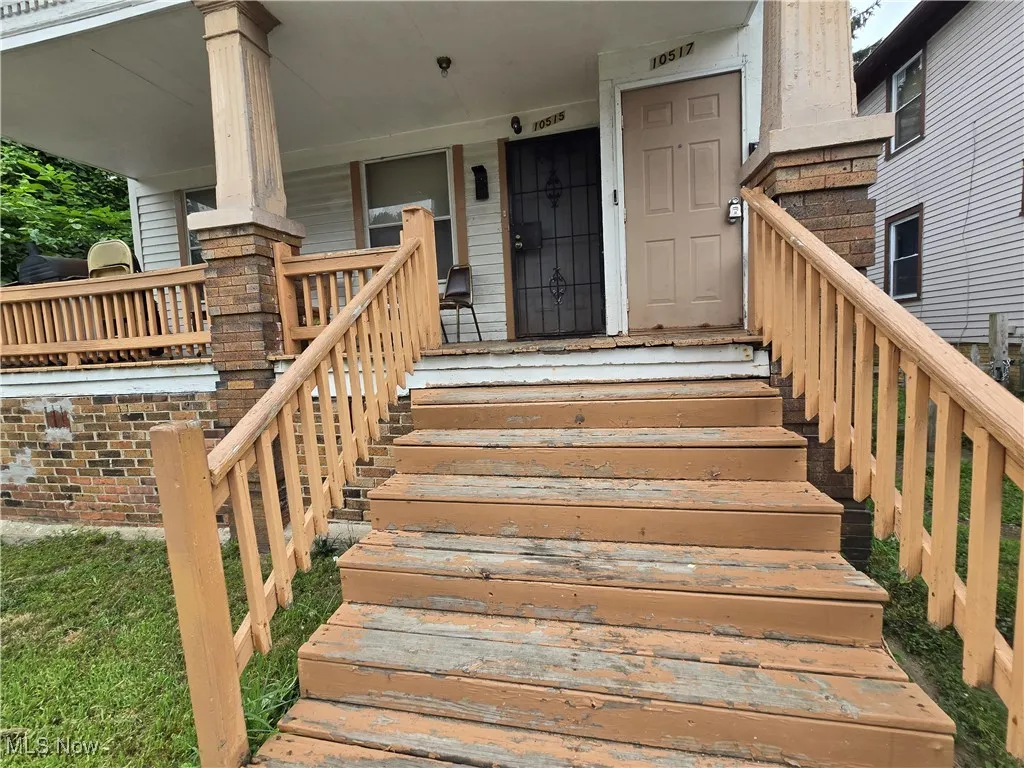 View of exterior entry with a porch