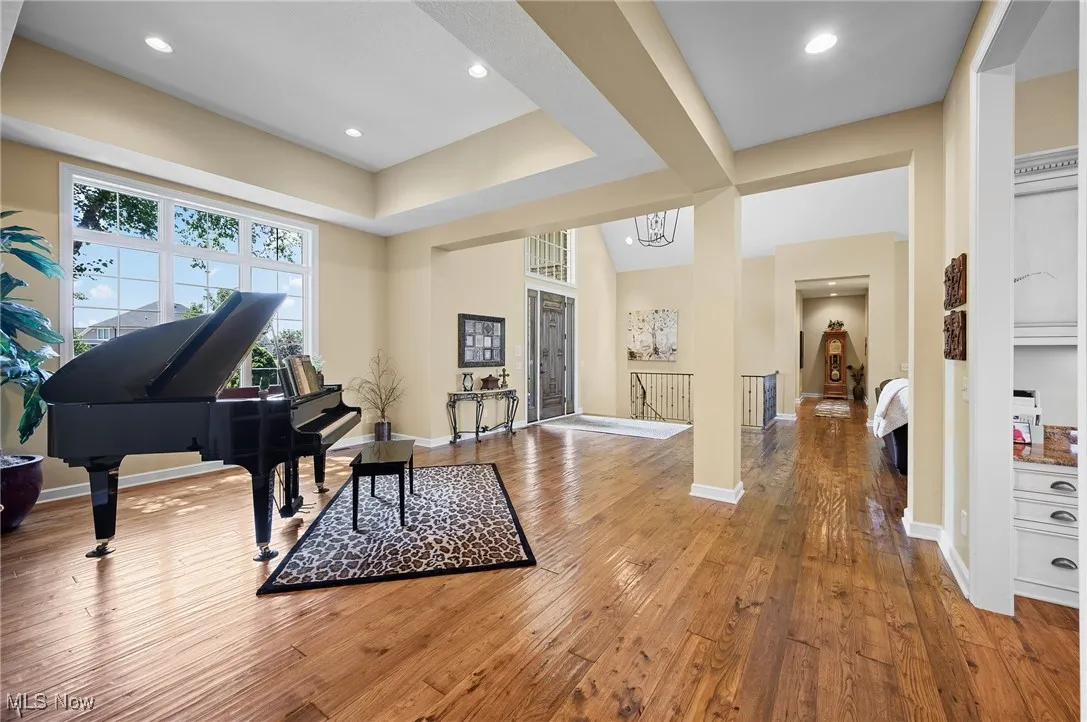 Living area with hardwood / wood-style flooring and recessed lighting