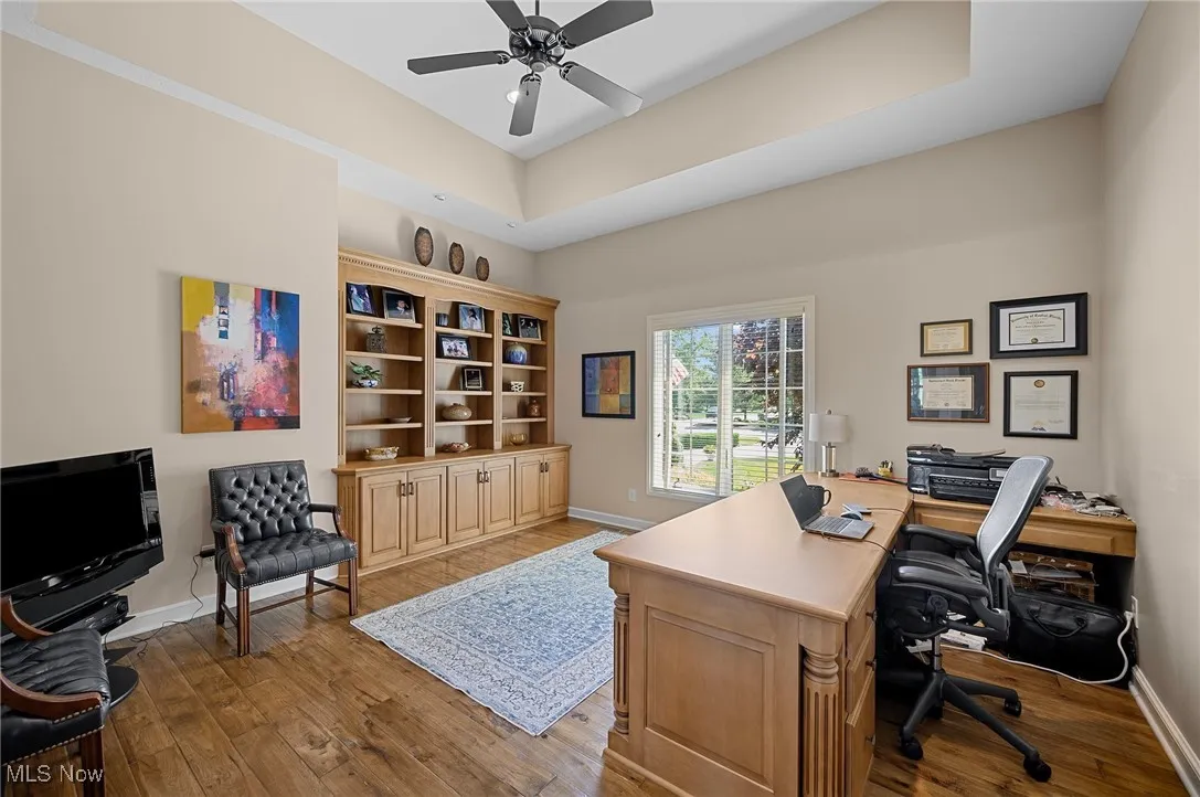 Home office featuring wood finished floors and a ceiling fan
