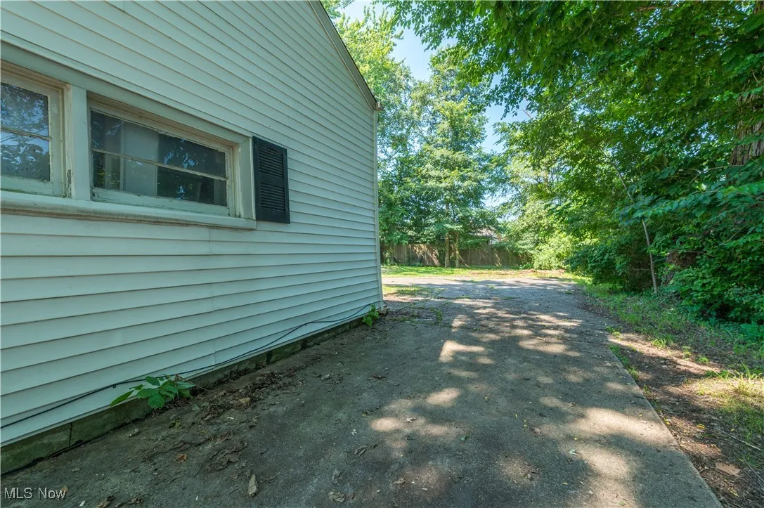 View of side of home featuring driveway
