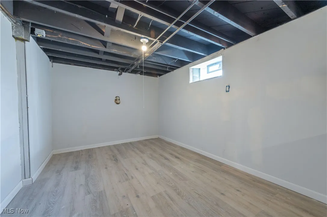 Below grade area featuring wood finished floors and baseboards