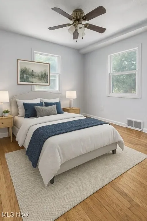 VIRTUALLY STAGED PHOTO! Bedroom with light wood-style floors and ceiling fan