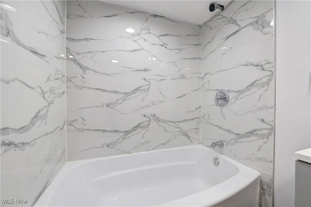 Full bathroom with shower / washtub combination