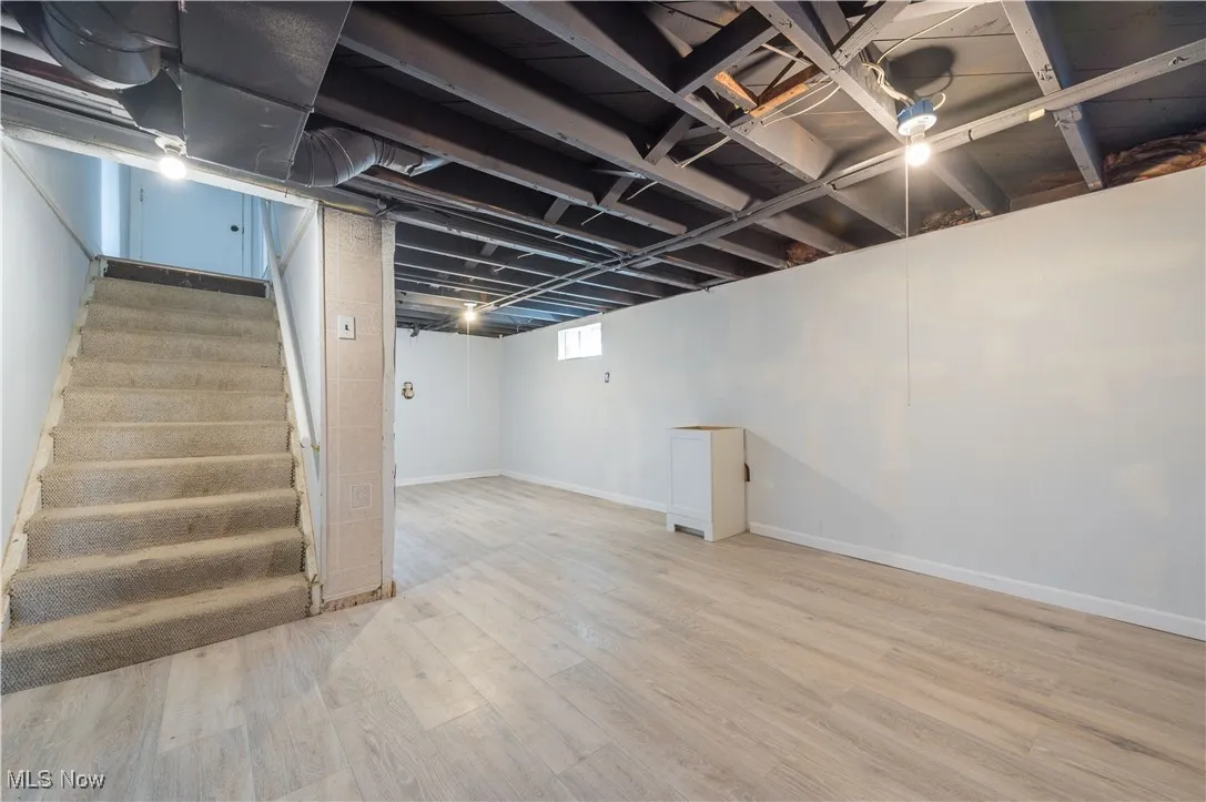 Below grade area with stairway and wood finished floors