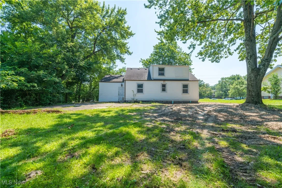 Rear view of house featuring a yard