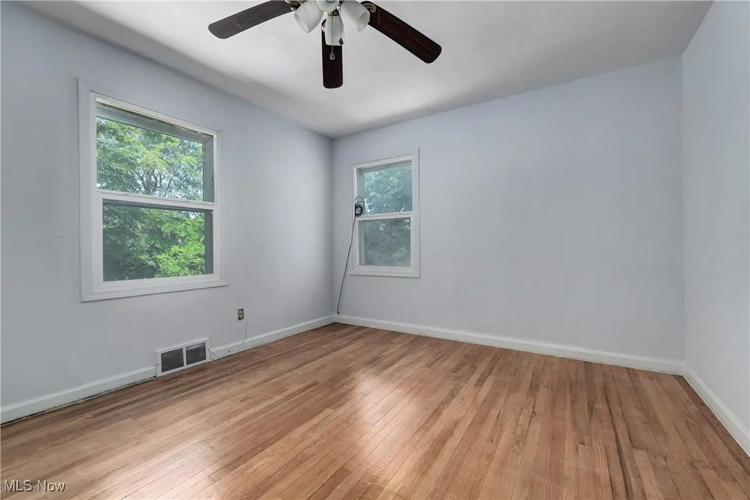 Spare room with light wood-style flooring and a ceiling fan