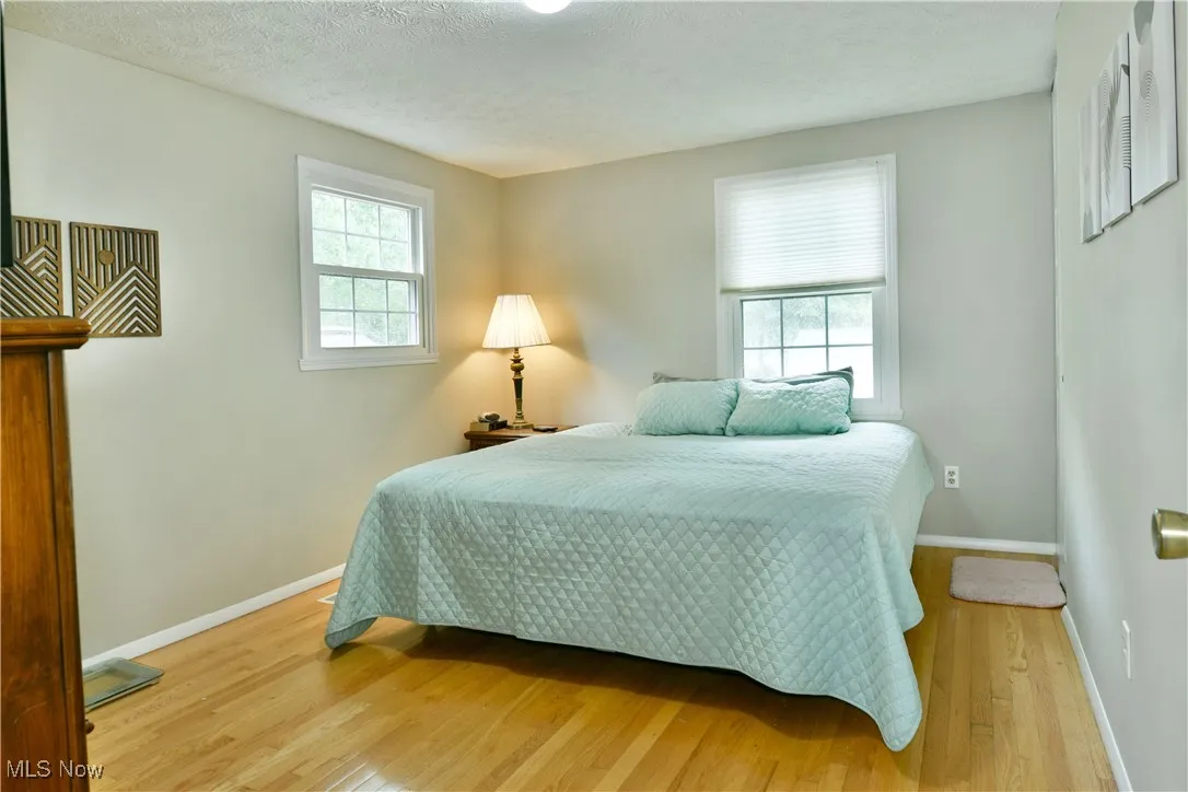 Bedroom featuring light wood finished floors and a textured ceiling