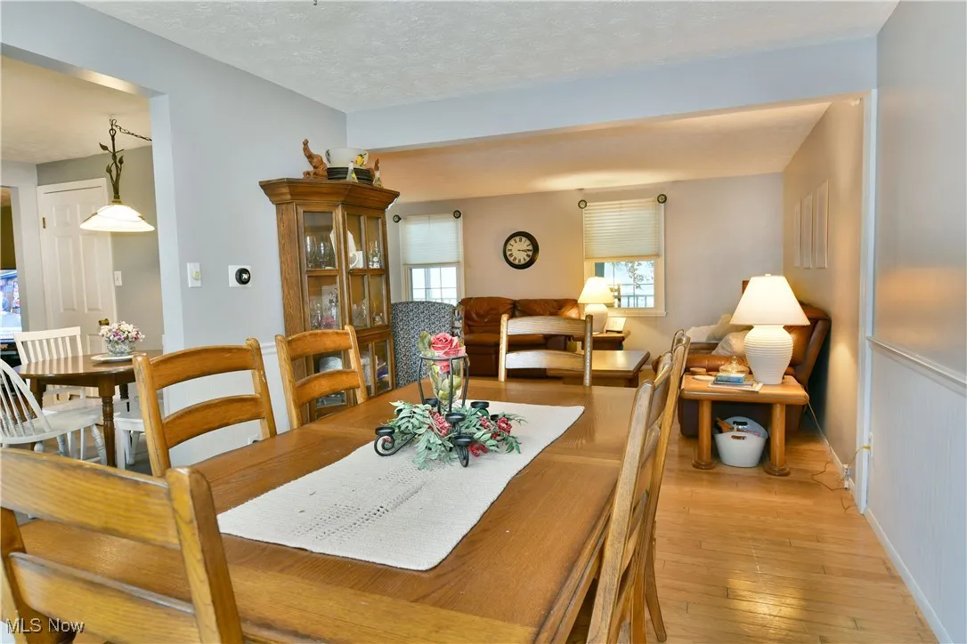 Dining space with light wood finished floors and a textured ceiling