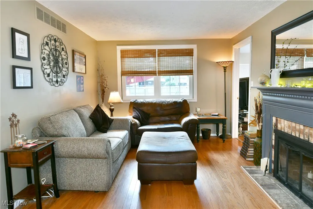 Living area featuring a tile fireplace and wood finished floors