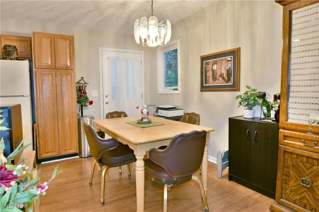 Dining space with a chandelier and light wood-style flooring
