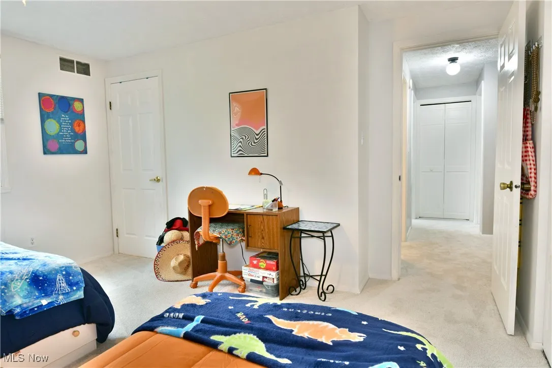 Bedroom featuring carpet flooring and baseboards