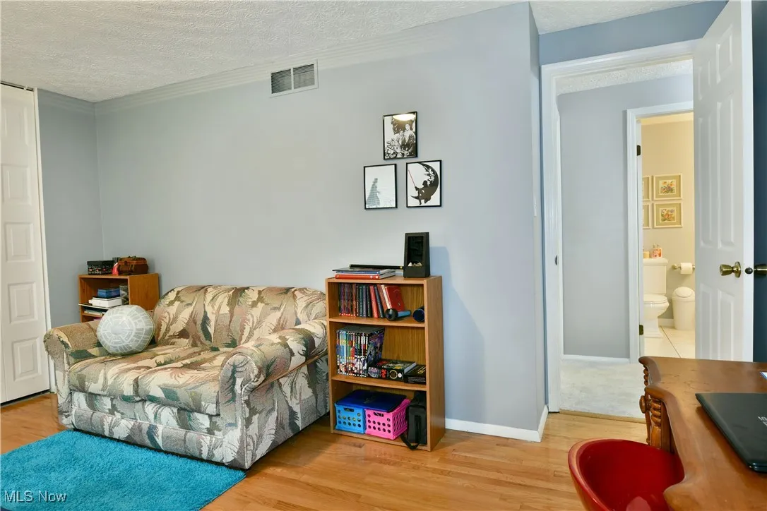 Living area featuring a textured ceiling and wood finished floors