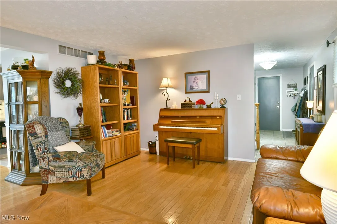 Sitting room featuring a textured ceiling and wood finished floors