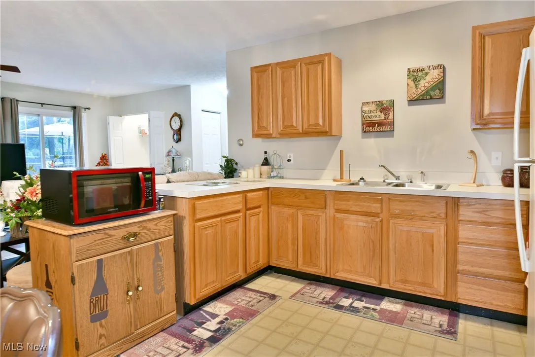 Kitchen with light countertops, a peninsula, and light flooring