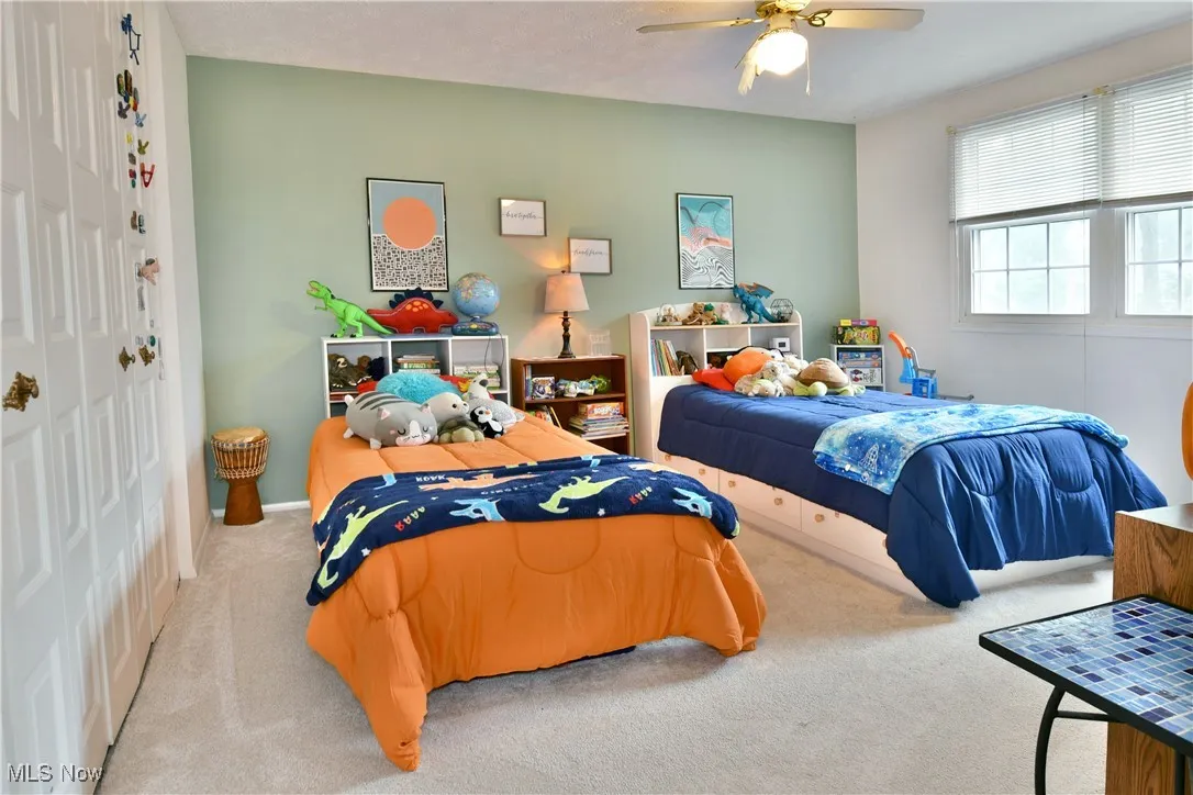 Bedroom featuring carpet floors, a closet, and ceiling fan