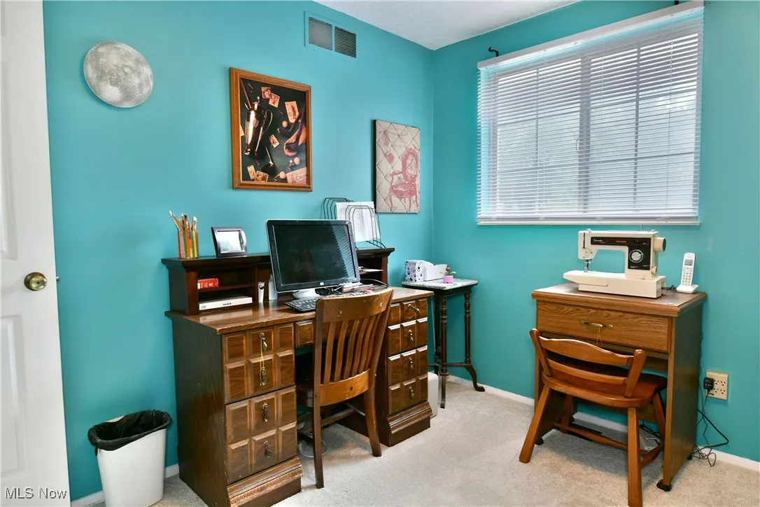 Home office with baseboards and carpet floors