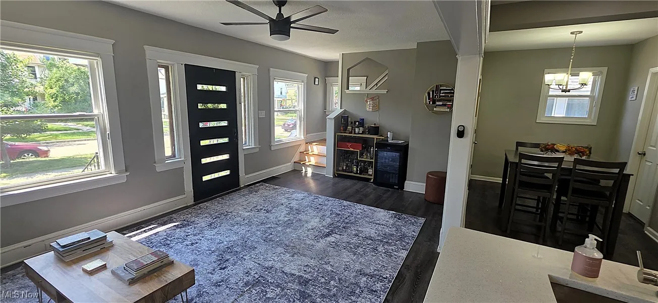 Entryway featuring ceiling fan, plenty of natural light, and a chandelier