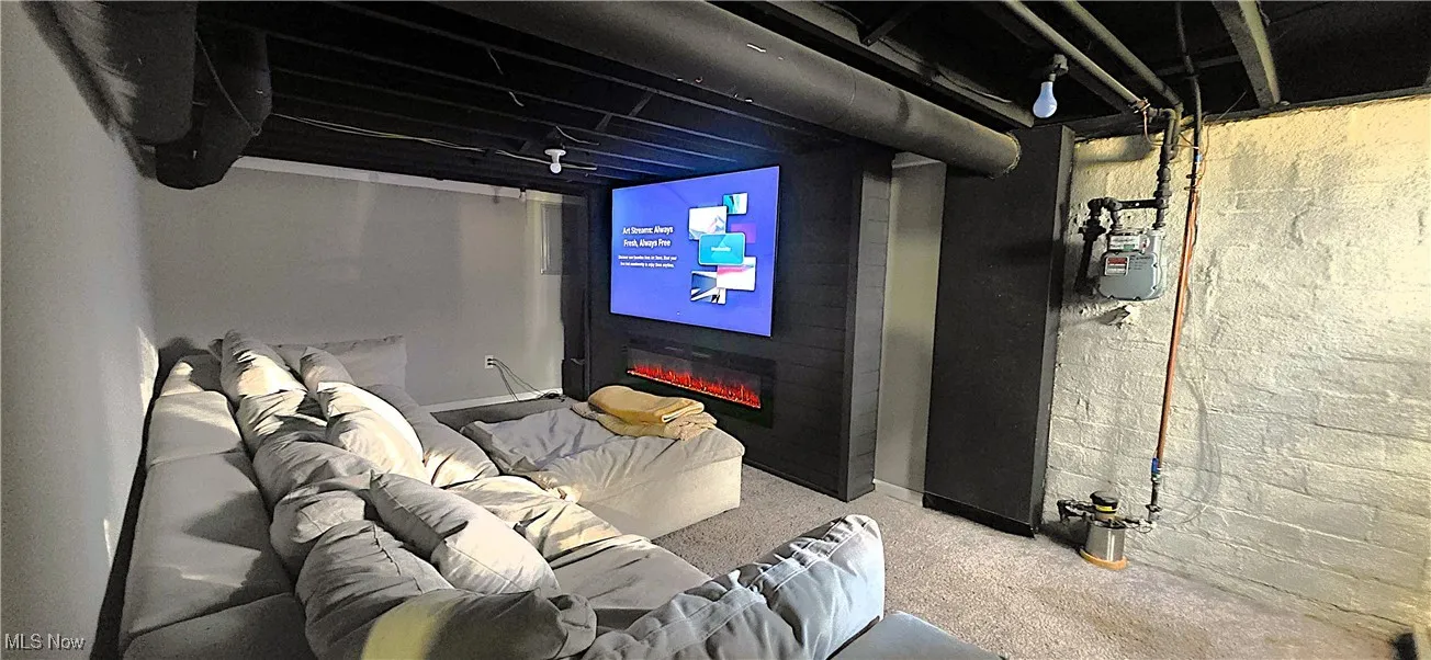 Home theater featuring a glass covered fireplace