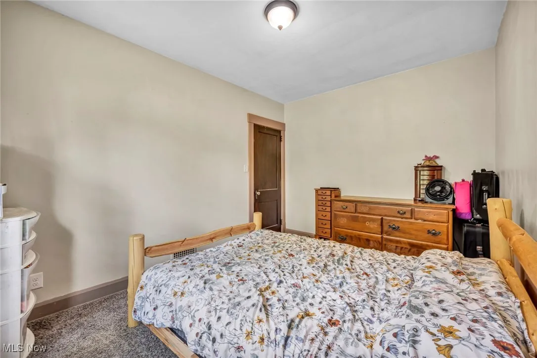 Carpeted bedroom with baseboards