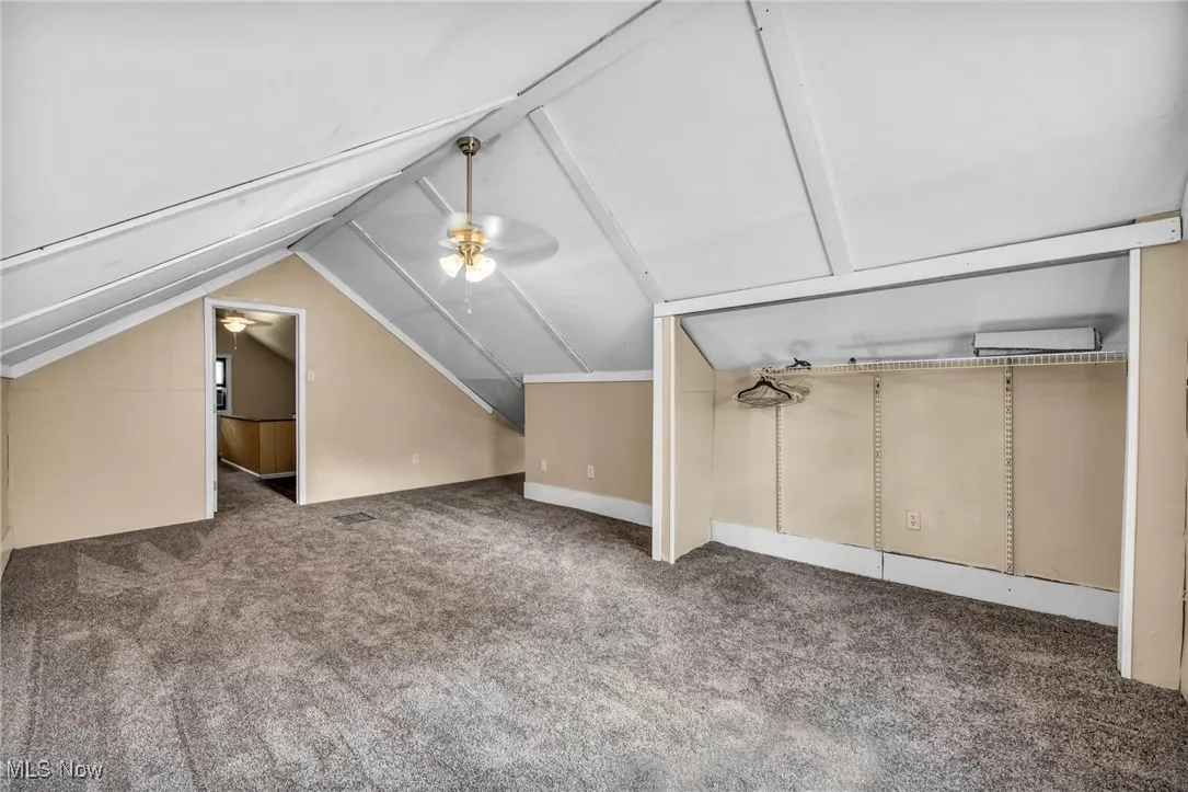Bonus room with a ceiling fan, carpet floors, and lofted ceiling