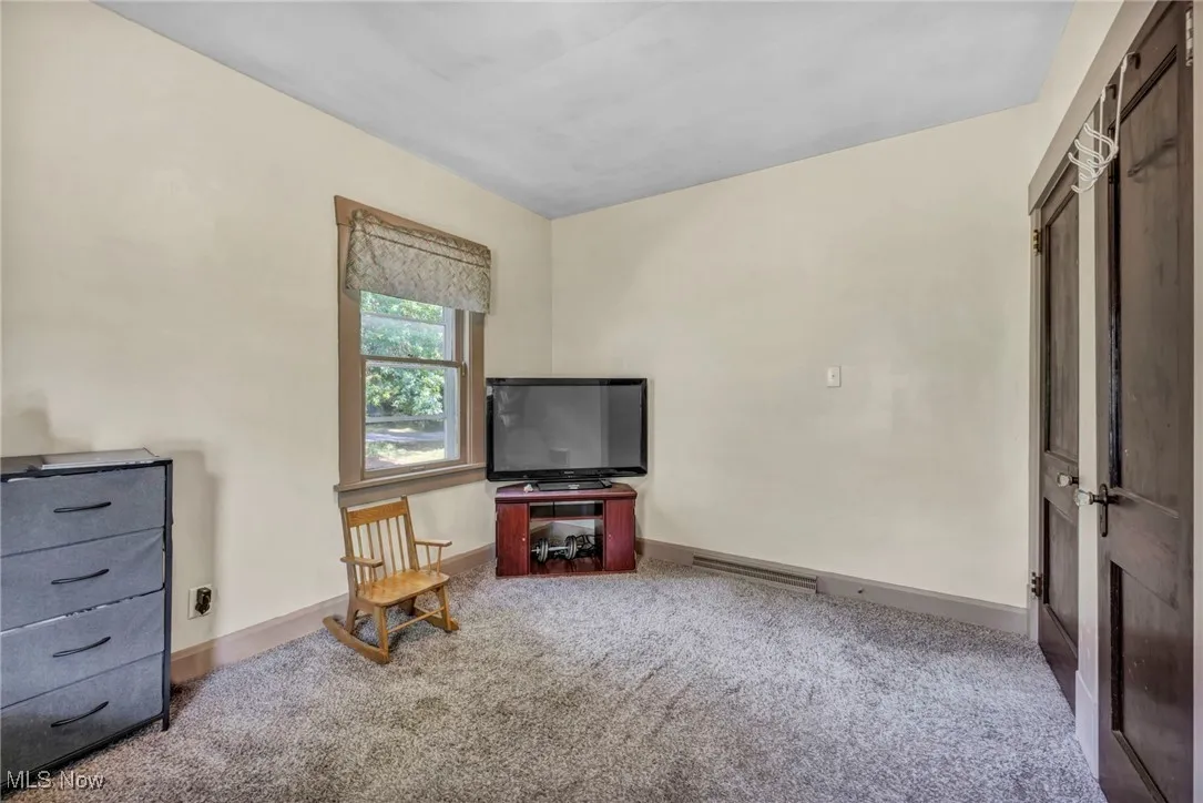 Sitting room with carpet floors and baseboards