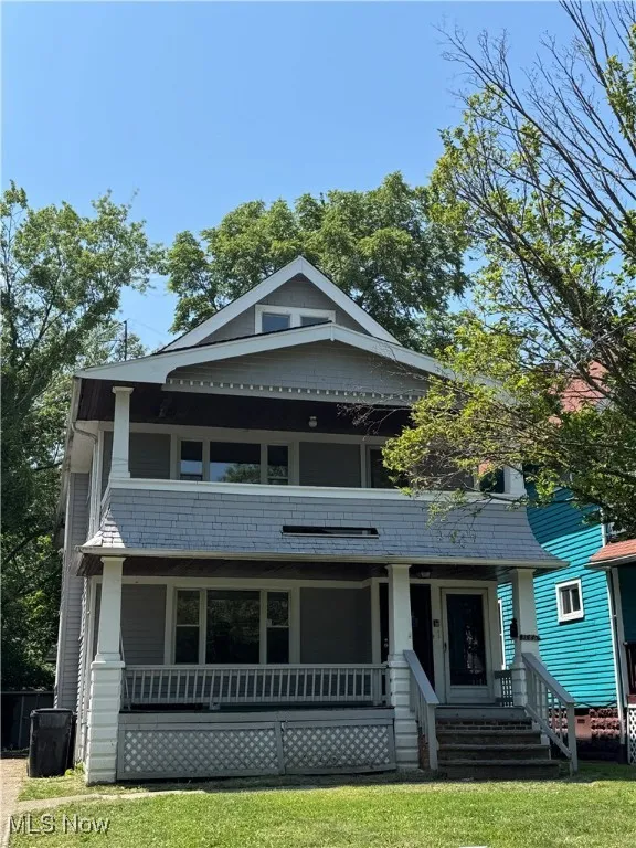 View of front of property with a porch and a front yard