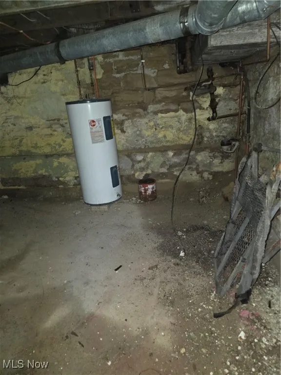 Unfinished below grade area featuring water heater