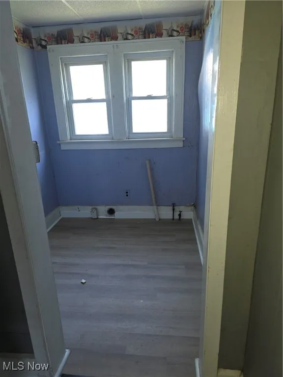 Laundry room with wood finished floors