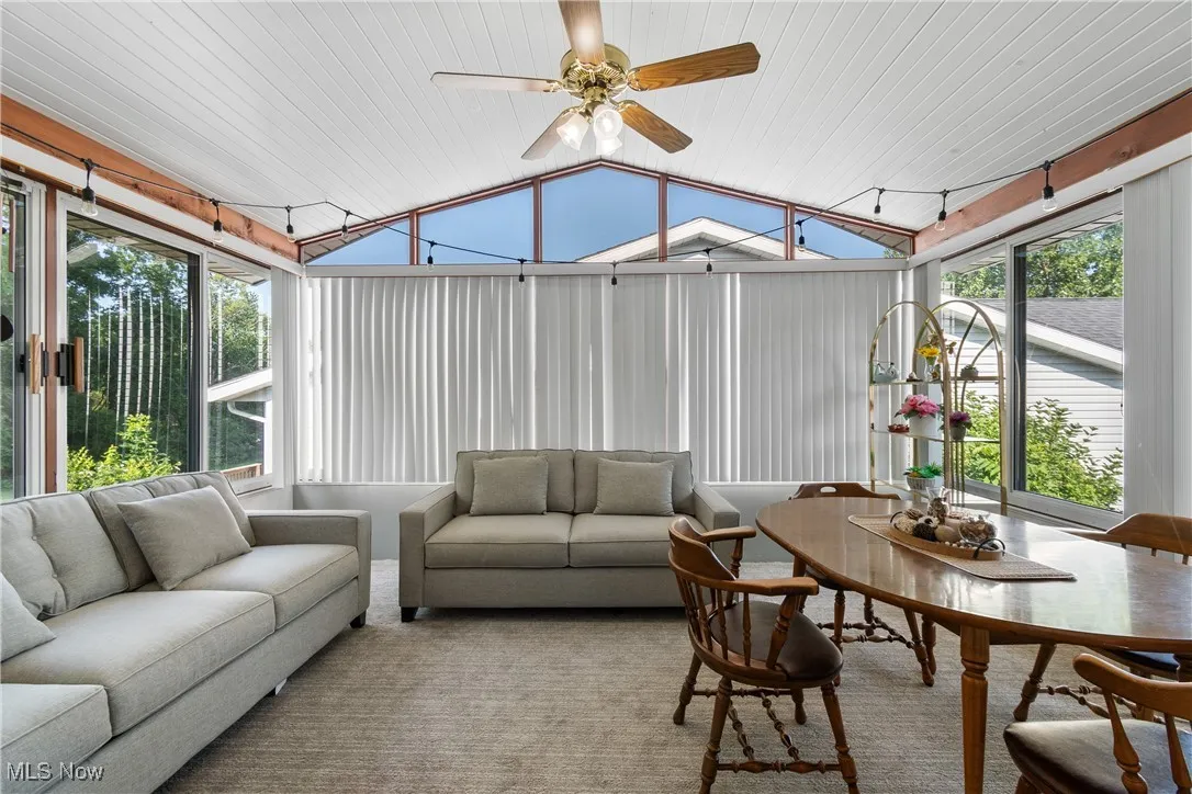 Sunroom / solarium featuring lofted ceiling