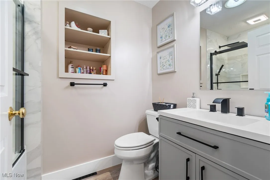 Bathroom featuring vanity and wood finished floors