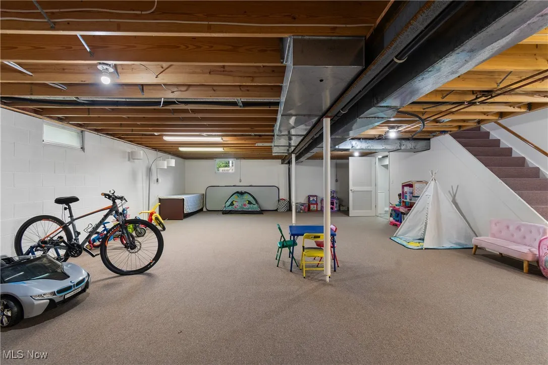 Basement featuring carpet floors and stairway