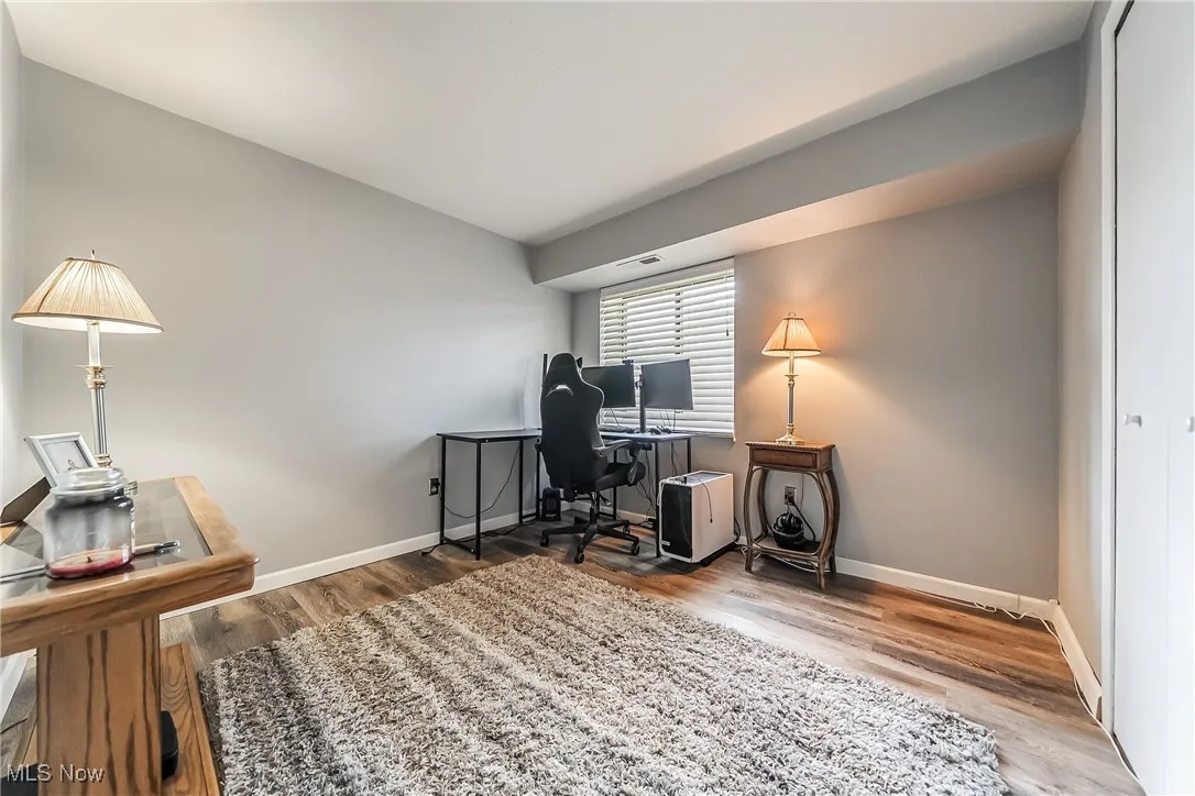 Office space featuring baseboards and wood finished floors