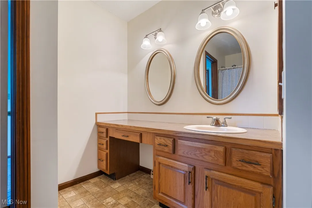 Partial view of the primary bathroom.    This has a large countertop.