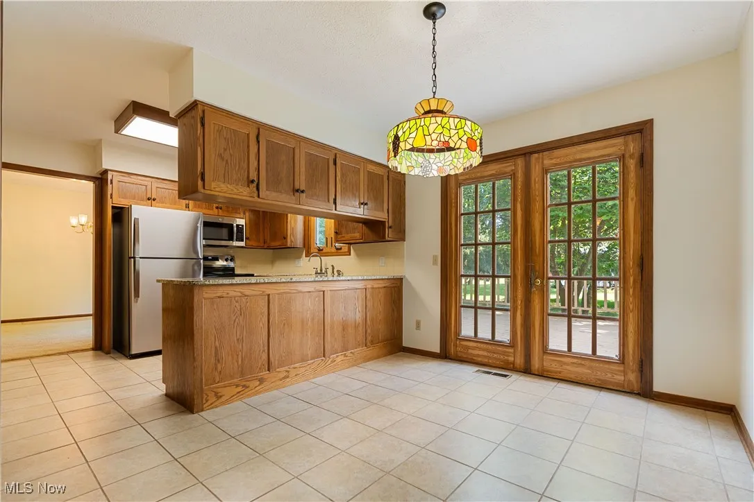 This view of the kitchen/dinette shows you the beautiful double doors that lead out to your deck and also shows the flow of the dining room area.