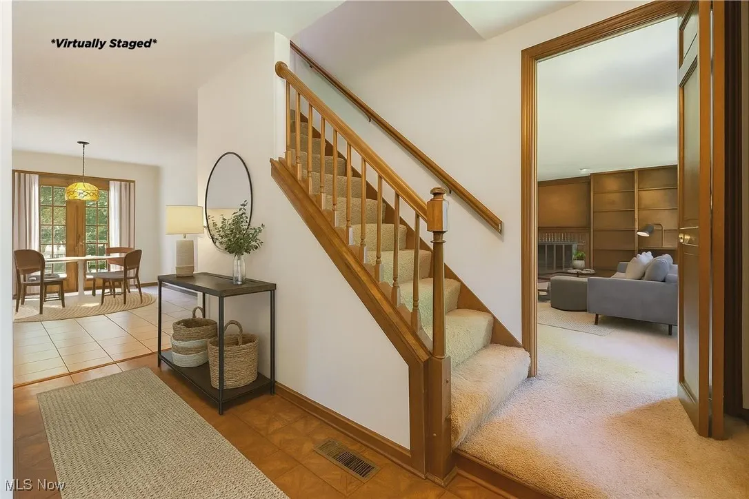 Virtually staged photo.  This shows you the warmth of the foyer and how it flows with the family room and kitchen.  Simple but elegant.