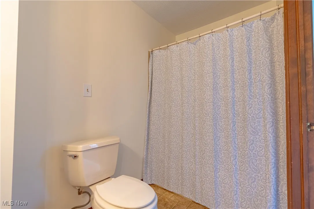 View of one of the commode/shower area in the home