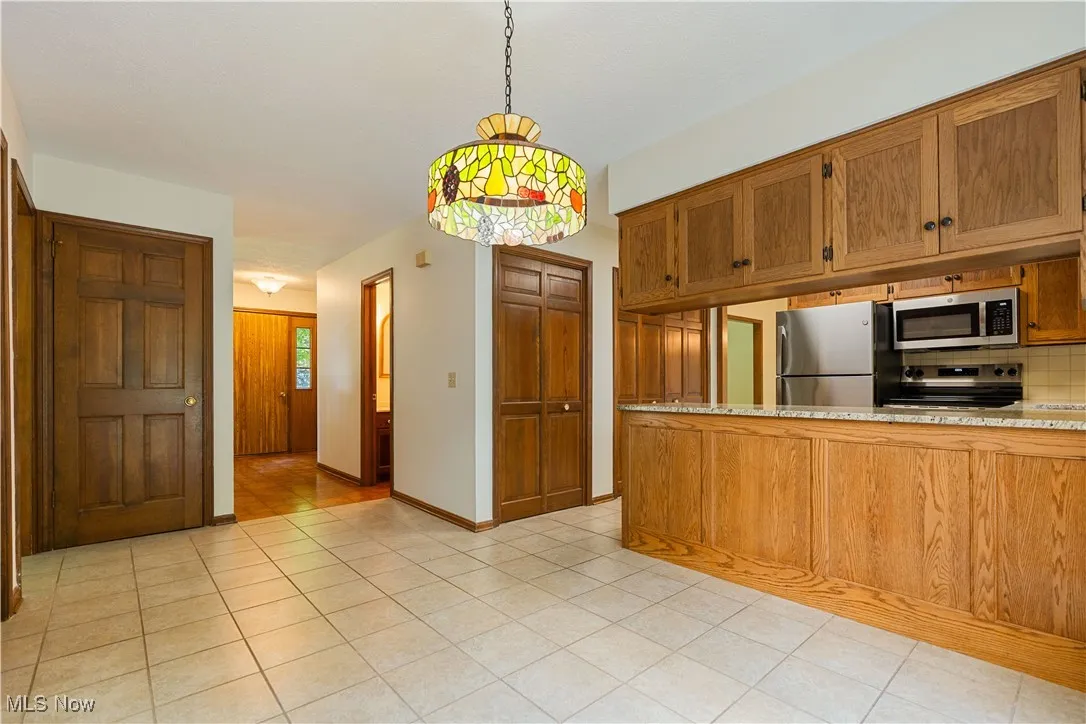 This view of the kitchen shows the large dinette and size of kitchen.