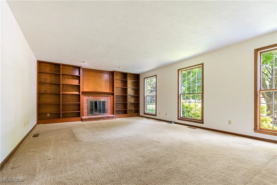 Large family room that will work with all size of furniture.  This room has a great deal of natural light.   The stunning double book case surrounds the fireplace.