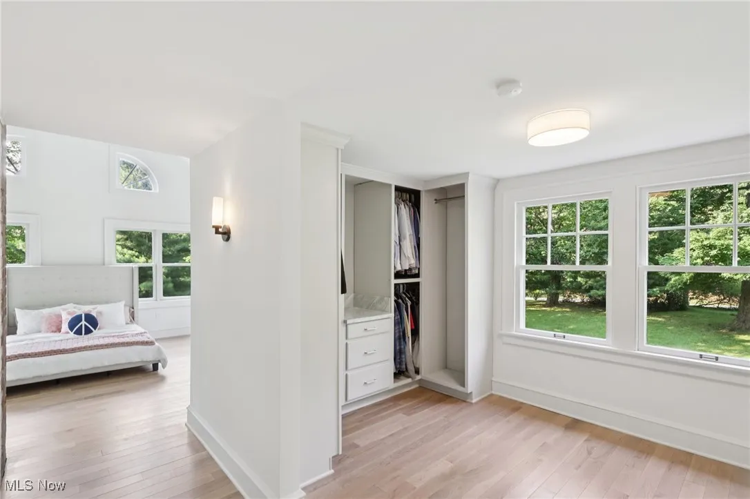 Unfurnished bedroom with light wood-style flooring and a closet