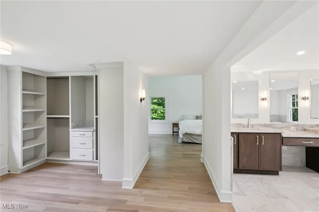 Ensuite bathroom featuring vanity and wood finished floors