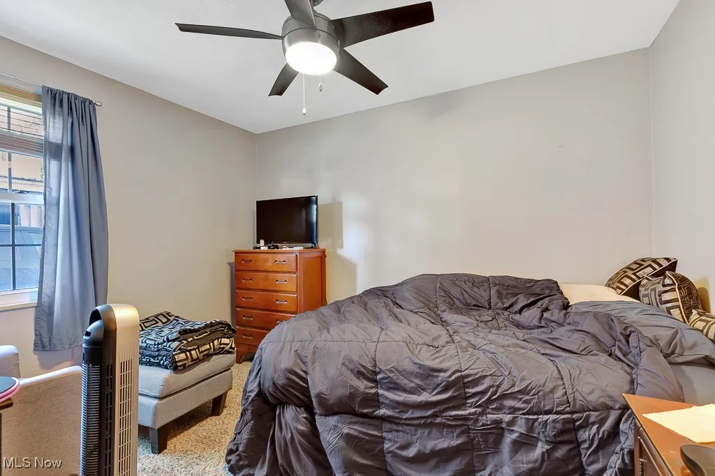 Bedroom with carpet and a ceiling fan