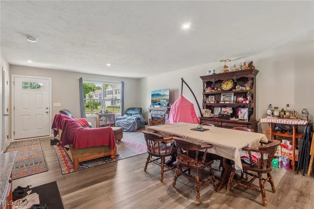 Dining area featuring wood finished floors, recessed lighting, and a textured ceiling
