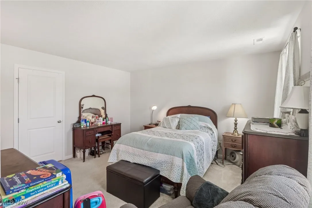 Bedroom with light colored carpet