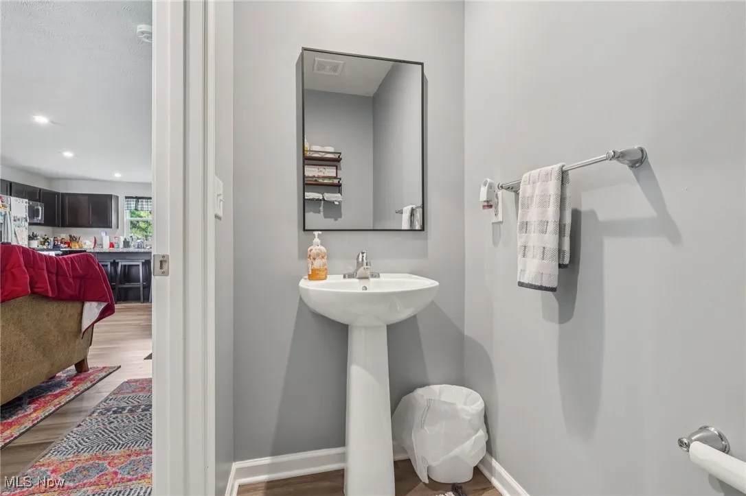 Bathroom with wood finished floors and recessed lighting