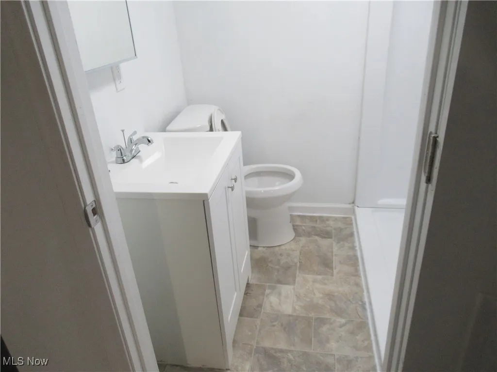 Bathroom with stone finish floors and vanity