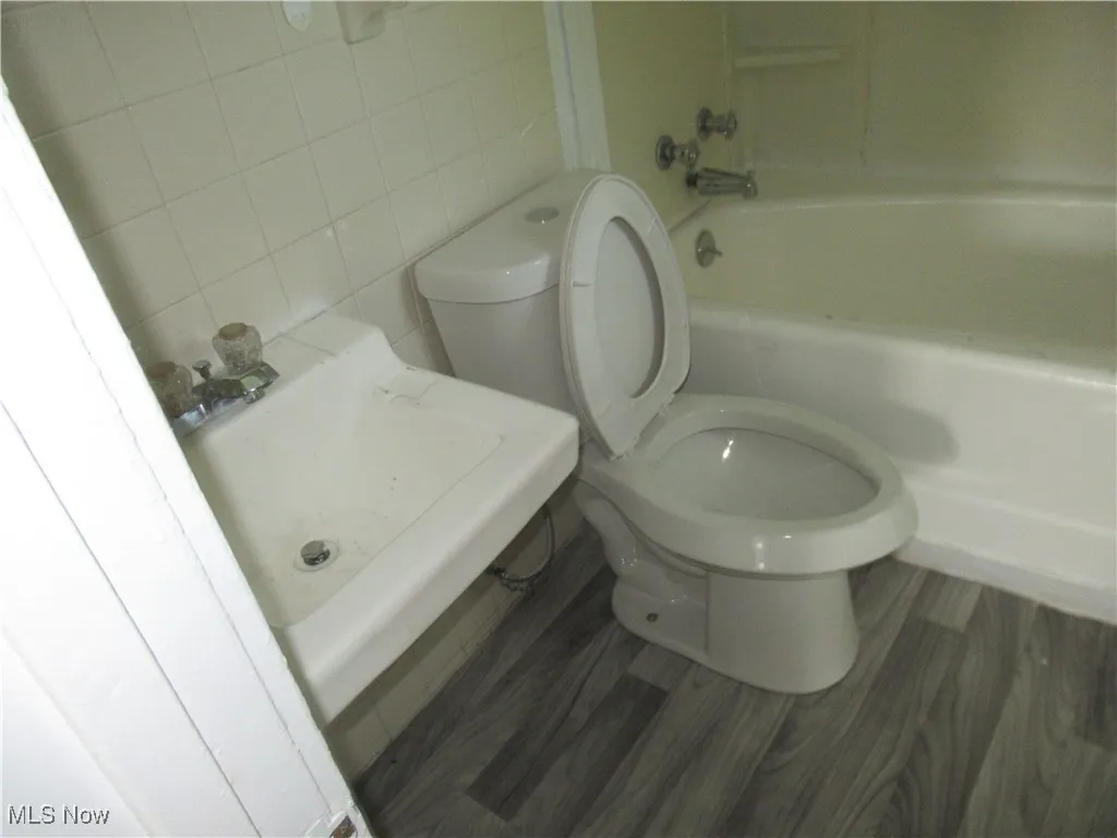Full bathroom featuring tile walls and shower / bathtub combination