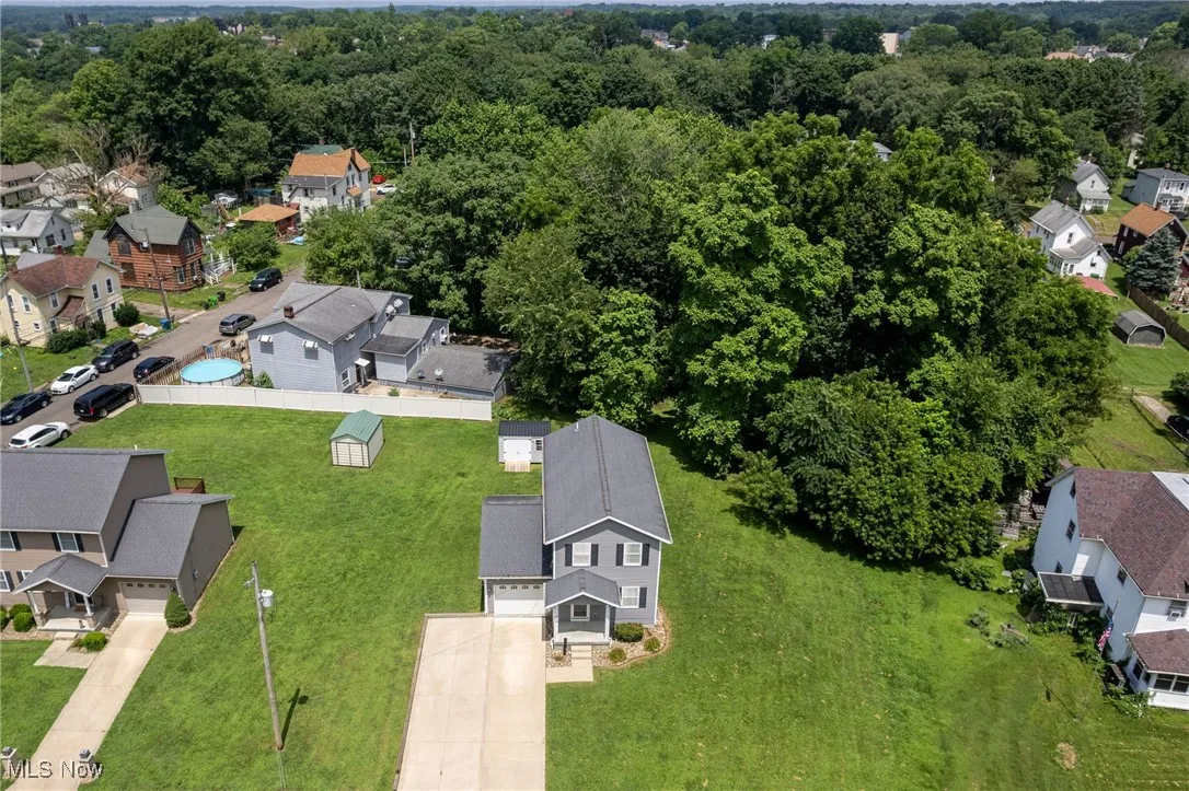 Aerial perspective of suburban area featuring a forest