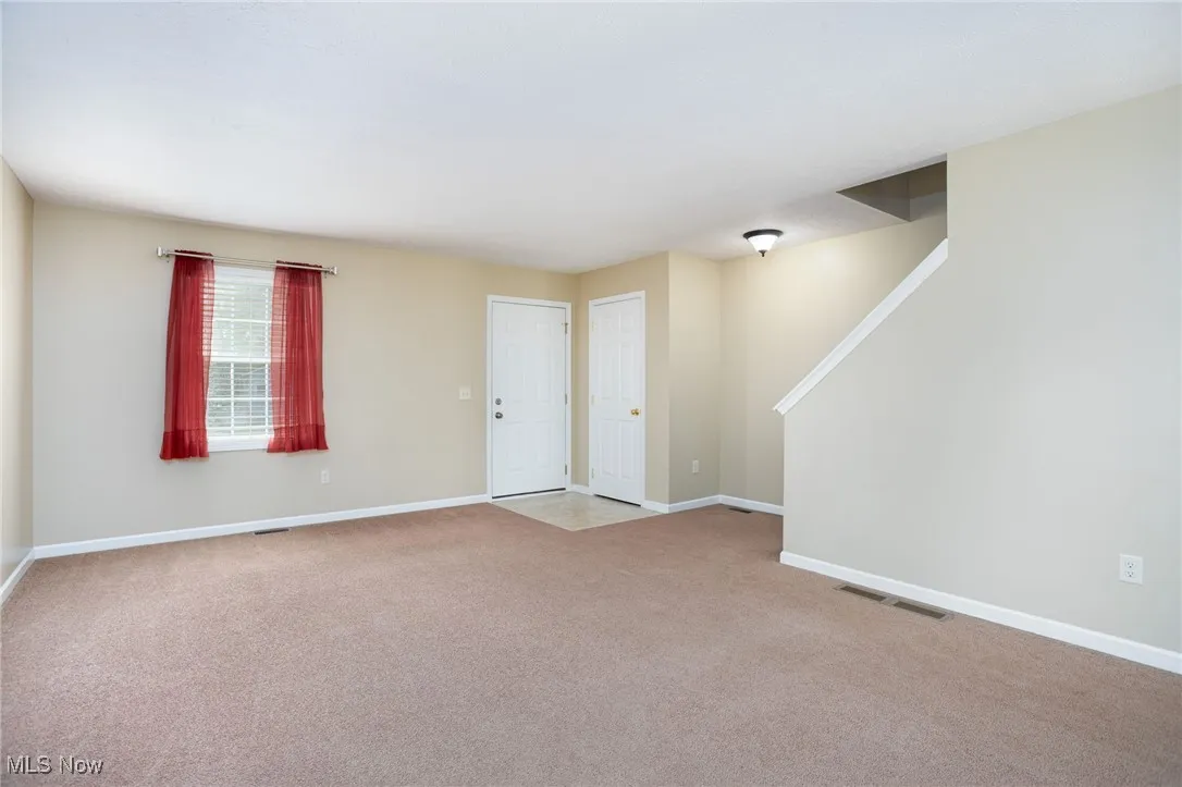 Entryway with carpet flooring and stairs