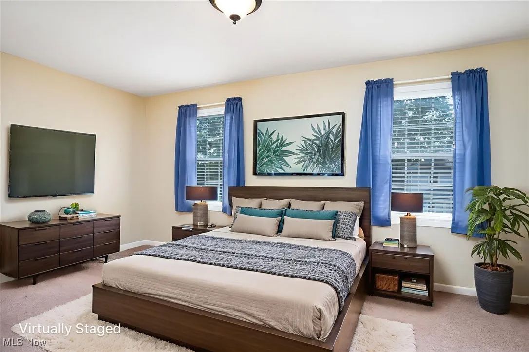 Bedroom featuring baseboards and carpet