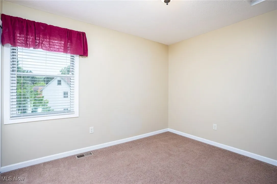 Carpeted spare room with plenty of natural light